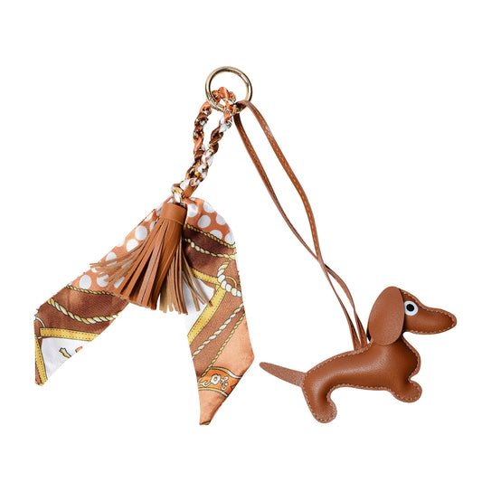 Tan padded sausage dog keyring with faux leather tassel and equestrian-themed satin scarf, available in several colours